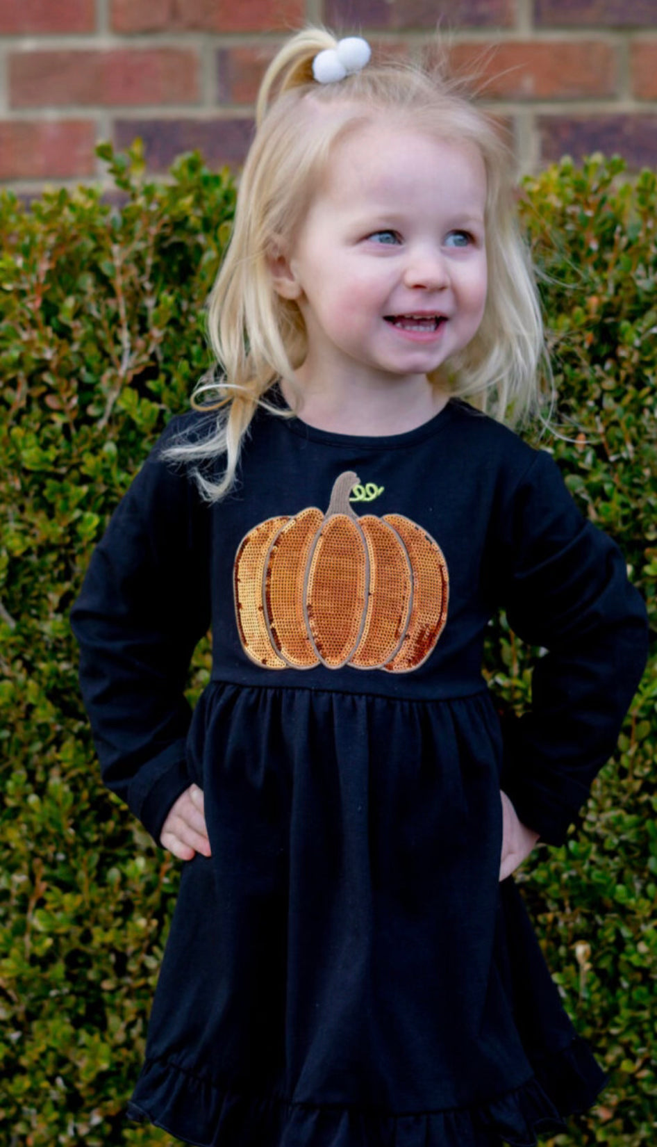 Black dress with pumpkin sequin appliqué